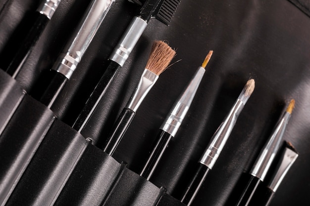 Different type of makeup brushes in a row