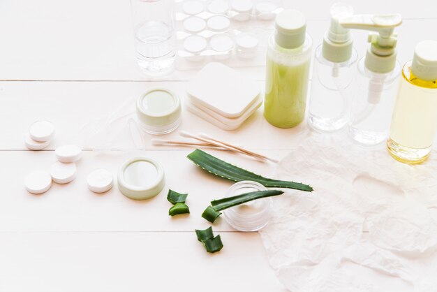 Different type of natural cosmetics product on white wooden table