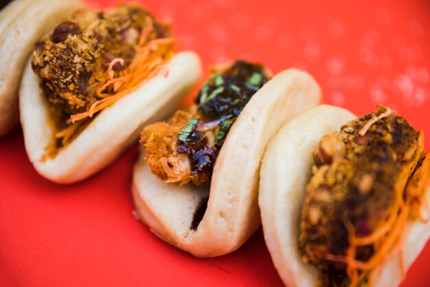 Different type of taiwan's traditional food gua bao on red background