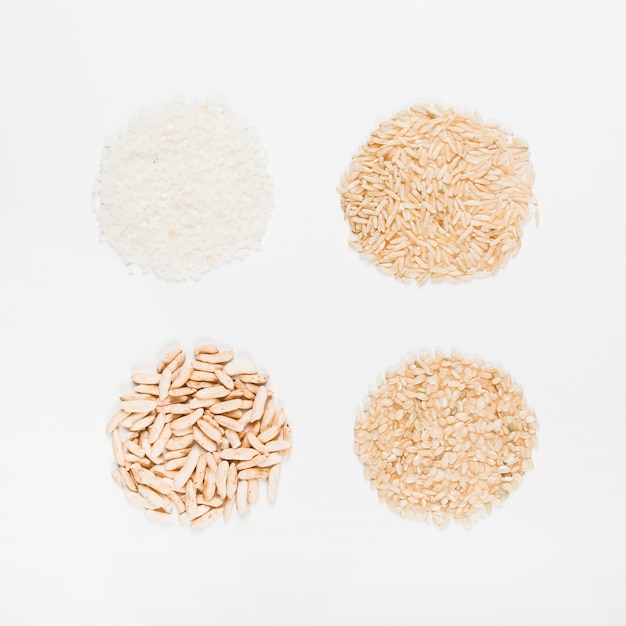 Free photo different type of uncooked rice in circular shape on white background