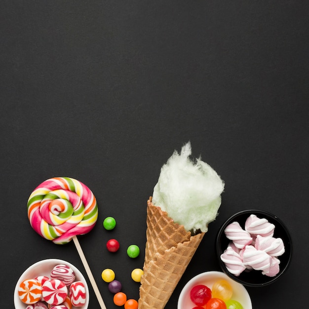 Free photo different types of candies on black table