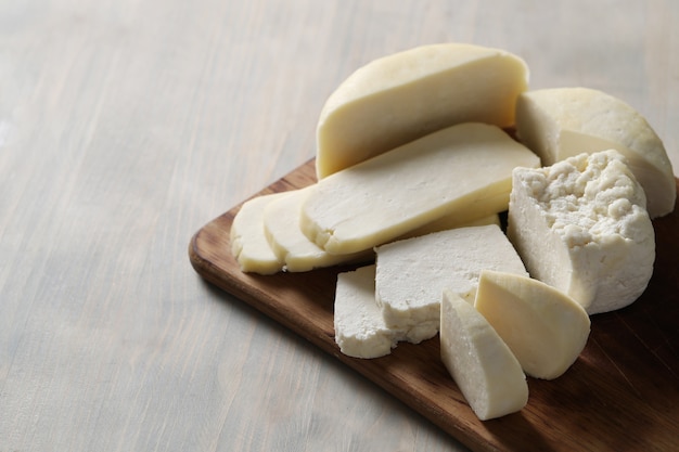 Different types of cheese on cutting board