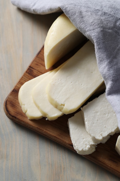 Different types of cheese on cutting board