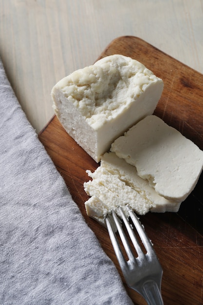 Different types of cheese on cutting board