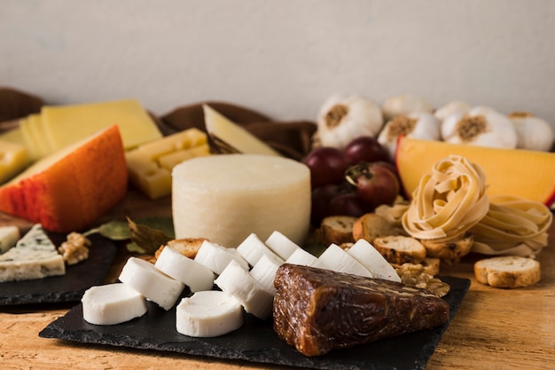 Different types of cheeses and ingredient on table