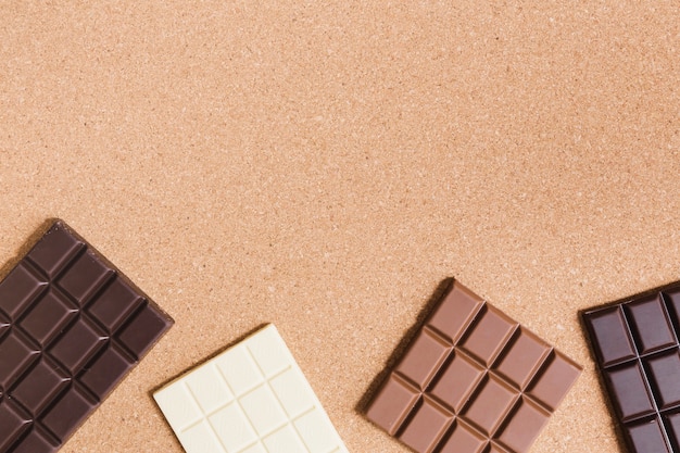 Different types of chocolate on orange background