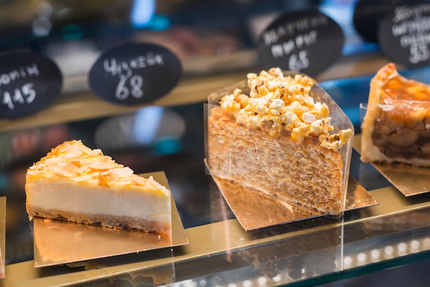 Different types of pastries in the glass cabinet with price tag