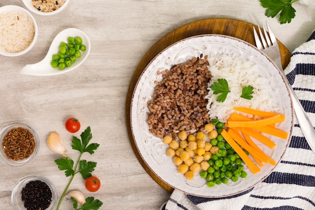 Different types of porridge with vegetables on wooden board 