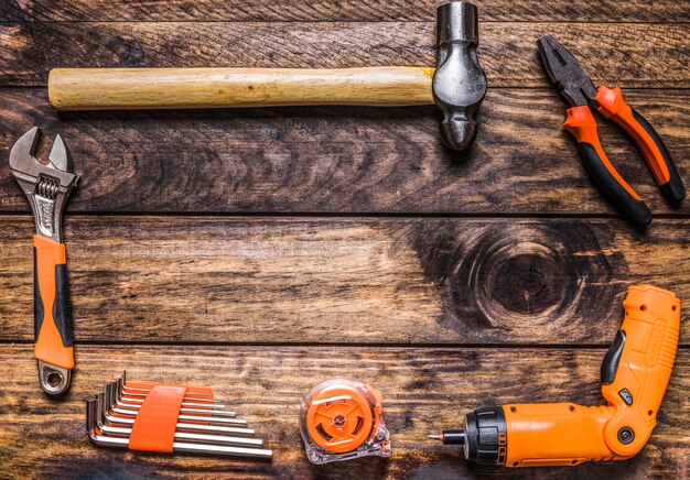 Different types of worktools on wooden background