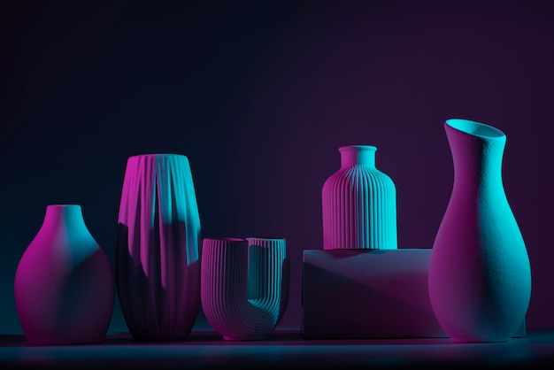 Free photo different vases with blue and purple light assortment