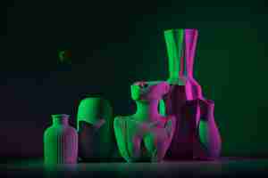 Free photo different vases with green and pink light