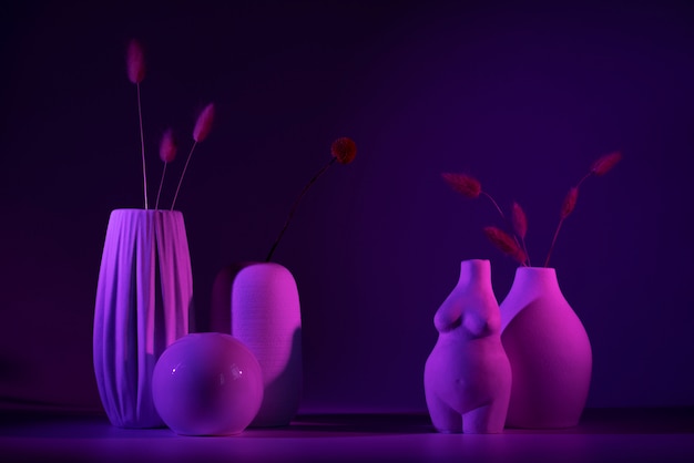 Free photo different vases with purple light