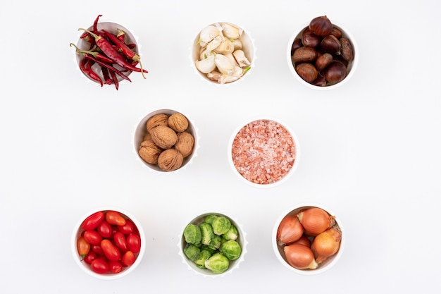 different vegetables in little white bowl on white