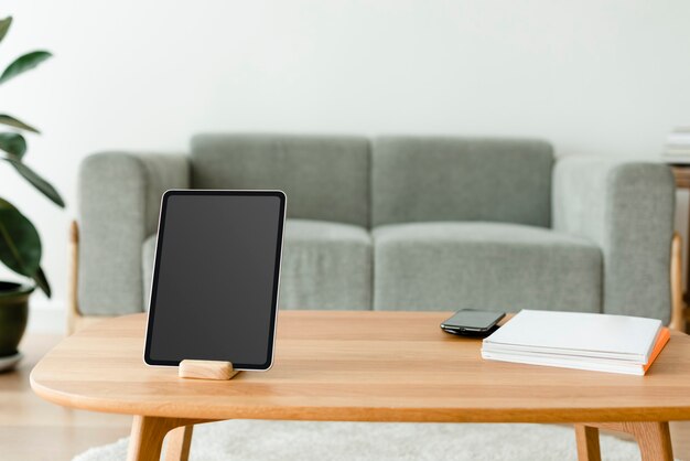 Digital tablet with blank screen on wooden table