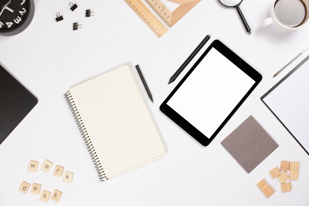 Digital tablet with stylus and office supplies on white background