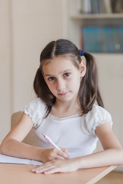 Diligent schoolgirl making notes