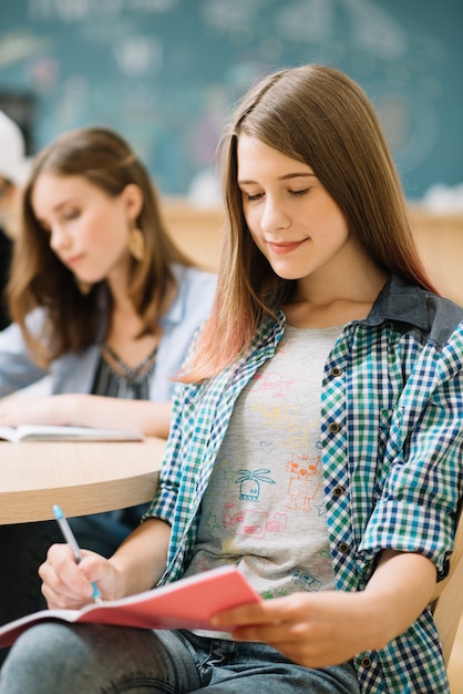 Free photo diligent student taking notes