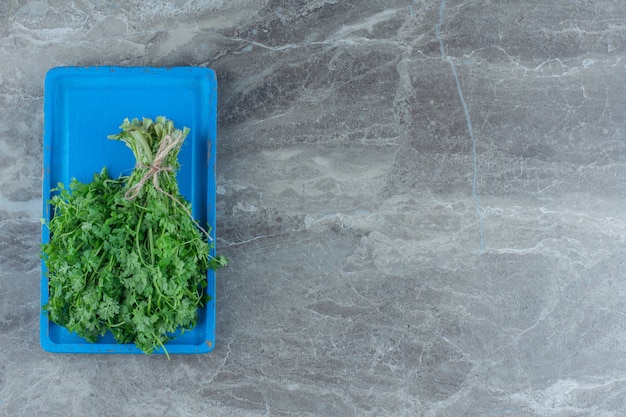 Dill and parsley on the tray , on the marble table.