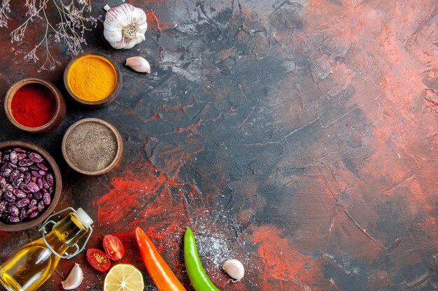 Dinner table fallen oil bottle beans and different spices on mix color table