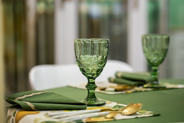 Dinner table setting idea with textured green glass goblets