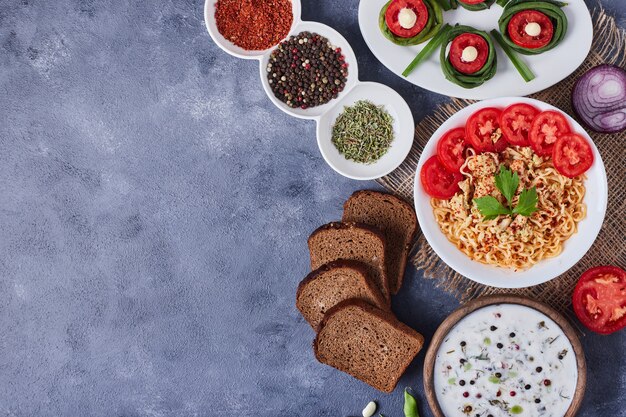 Dinner table with mixed foods in white dishes on a piece of burlap.