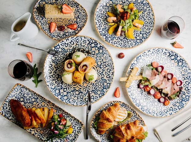 Dinner table with mixed foods.