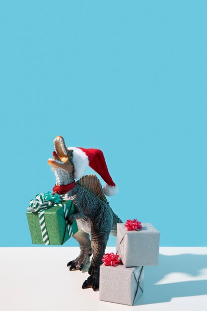 Dinosaur toy wearing santa hat