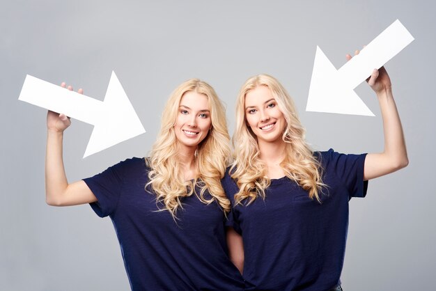 Direction of arrows shows beautiful twins
