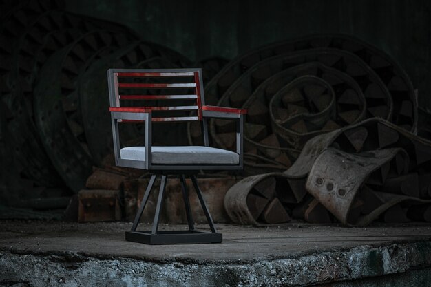 Director's chair with a weathered red paint placed with industrial materials