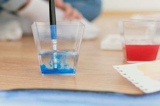 Dirty brush paint of blue acrylic in the water