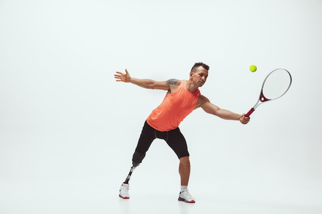 Disabled athlete on white background, tennis player