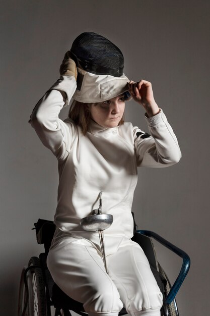 Disabled fencer in special equipment sitting in a wheelchair