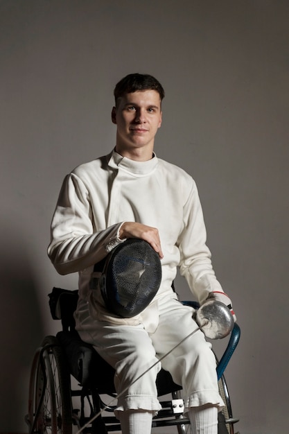 Disabled fencer in special equipment sitting in a wheelchair