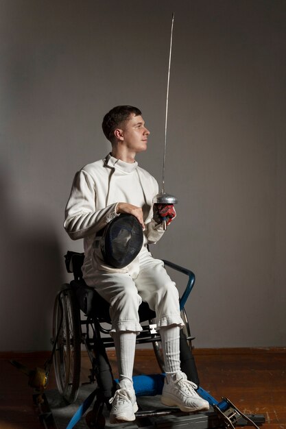 Disabled fencer in special equipment sitting in a wheelchair