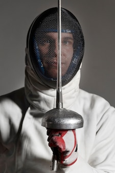Disabled fencer in special equipment sitting in a wheelchair