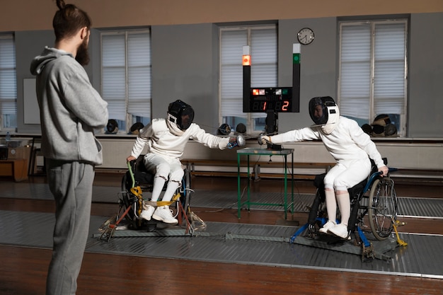 Disabled fencers in special equipment fighting from their wheelchairs