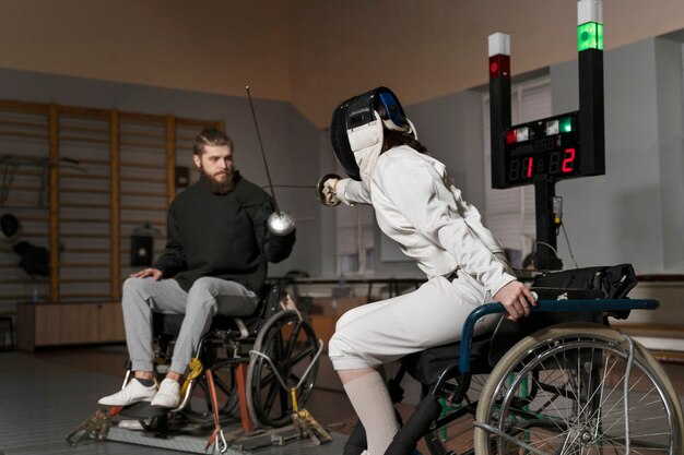 Disabled fencers in special equipment fighting from their wheelchairs