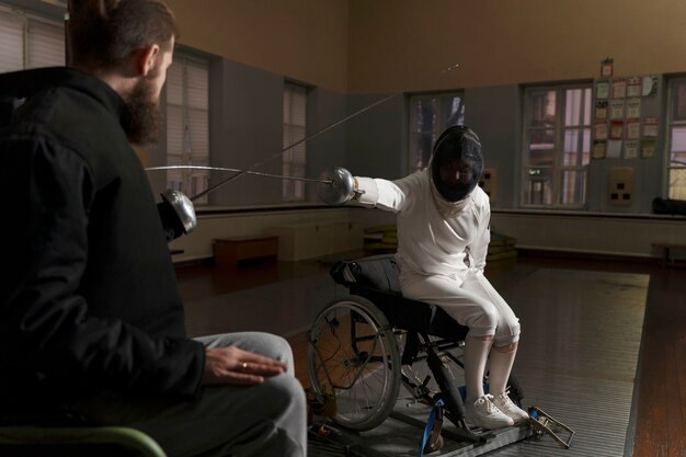 Disabled fencers in special equipment fighting from their wheelchairs