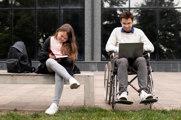 Disabled man helping girl learn