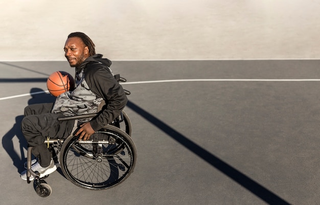 Disabled man in wheelchair playing basketball