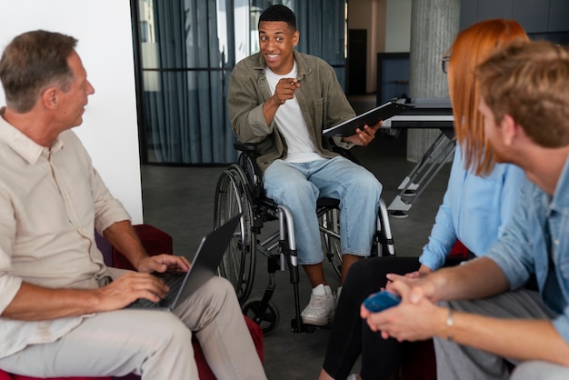 Инвалид в инвалидной коляске работает в офисе