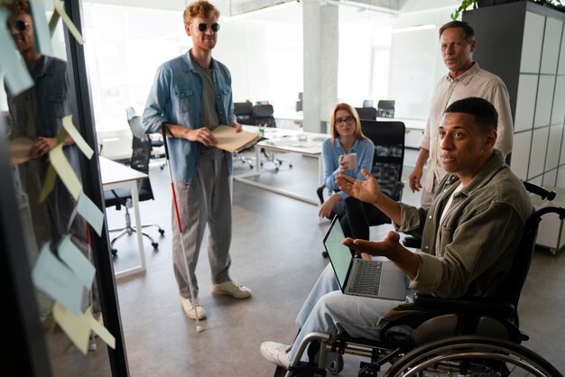 Disabled man in a wheelchair working at his office job