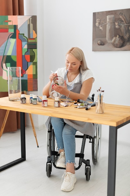 Disabled person in wheelchair painting