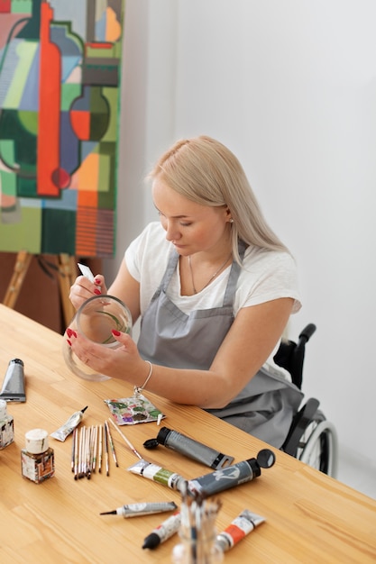 Disabled person in wheelchair painting