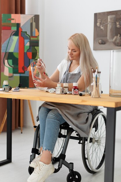 Disabled person in wheelchair painting