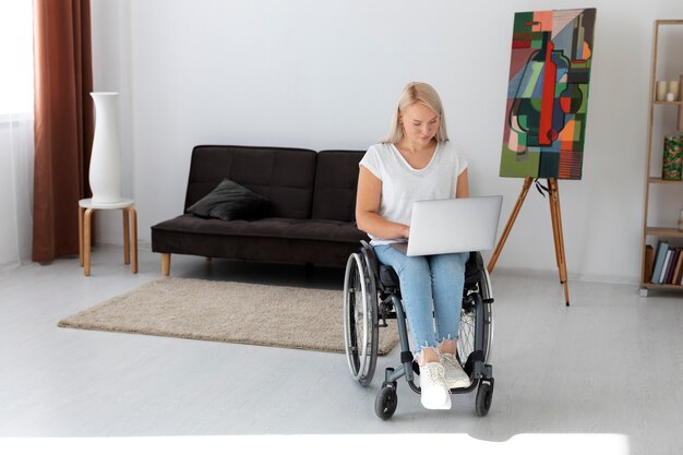 Disabled person in wheelchair working on laptop