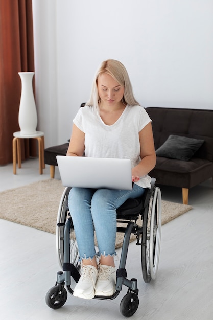 Disabled person in wheelchair working on laptop