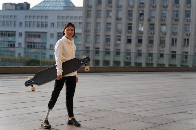 Disabled person with skateboard outdoors