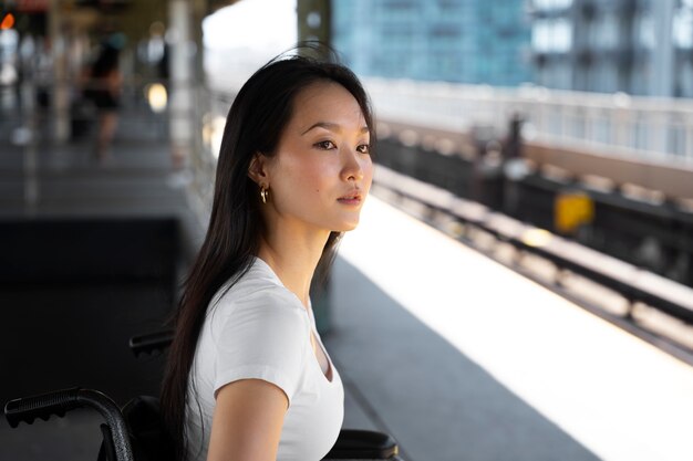 Disabled woman at train station side view