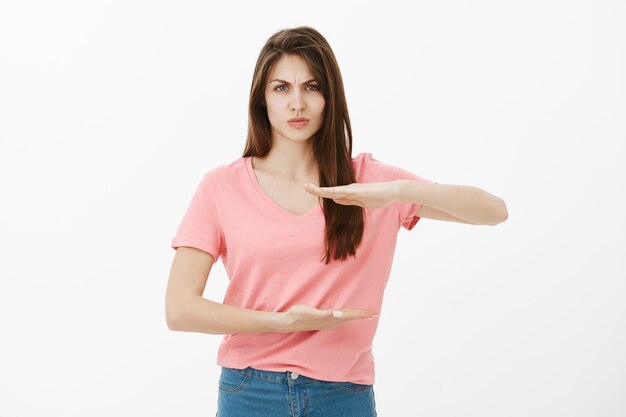 Disappointed brunette woman posing in the studio